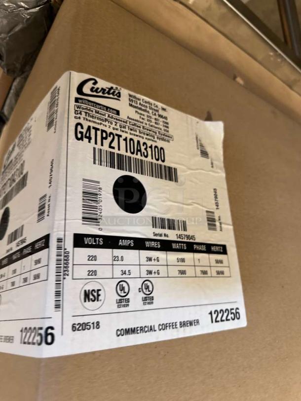 Brand new Curtis G4 ThermoPro Twin Coffee Brewer box, Model G4TP2T10A3100, showing specifications and serial numbers.