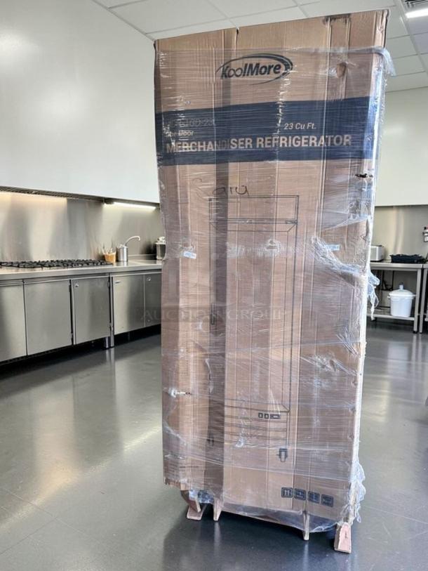 Brand new KoolMore MDR-1GD-23C commercial refrigerator in packaging. Visible model details: glass door, 23 cu ft.
