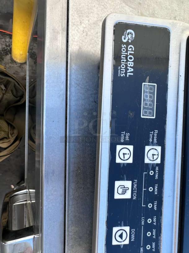 Global Solutions GS1561 induction cooker, 1800W, NSF-certified, sleek silver design, control panel with timer and function buttons, excellent condition.