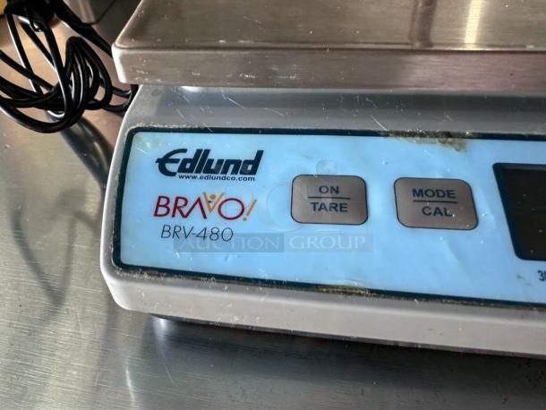 Edlund BRAVO BRV-480 digital portion scale, silver, NSF certified, on/tare and mode/cal buttons visible, fully operational.