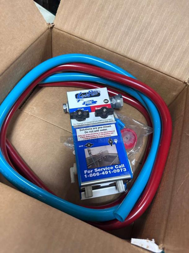Brand new SinkRite SSDC 3-Compartment Sink Dispenser with red and blue hoses, NSF certified, in original packaging.