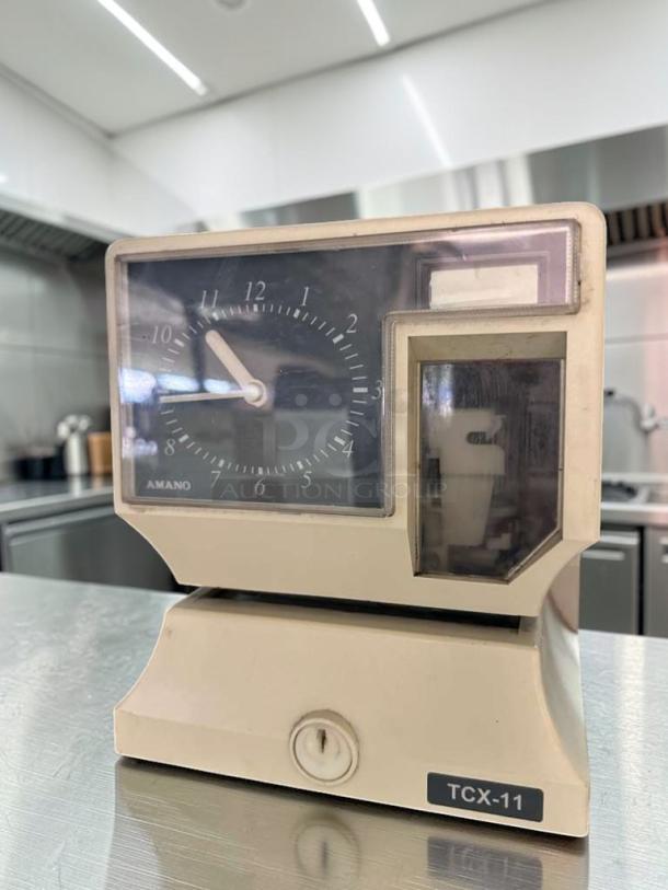 Amano TCX-11 analog time recorder. Elite condition, fully operational. UL Listed. Model and brand labels visible.