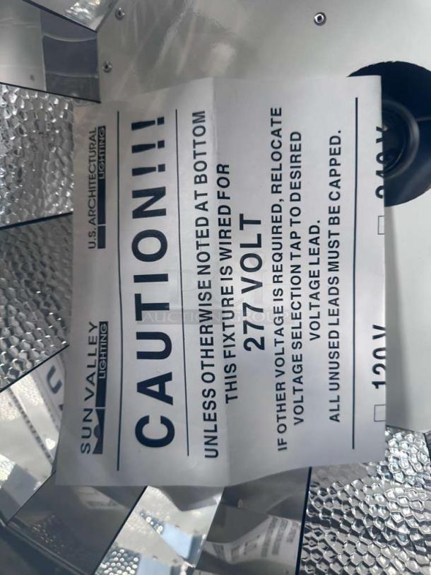 Sun Valley Architectural Lighting 24x24 ceiling light fixture. Reflective housing, 277V, fully tested. Visible caution label.