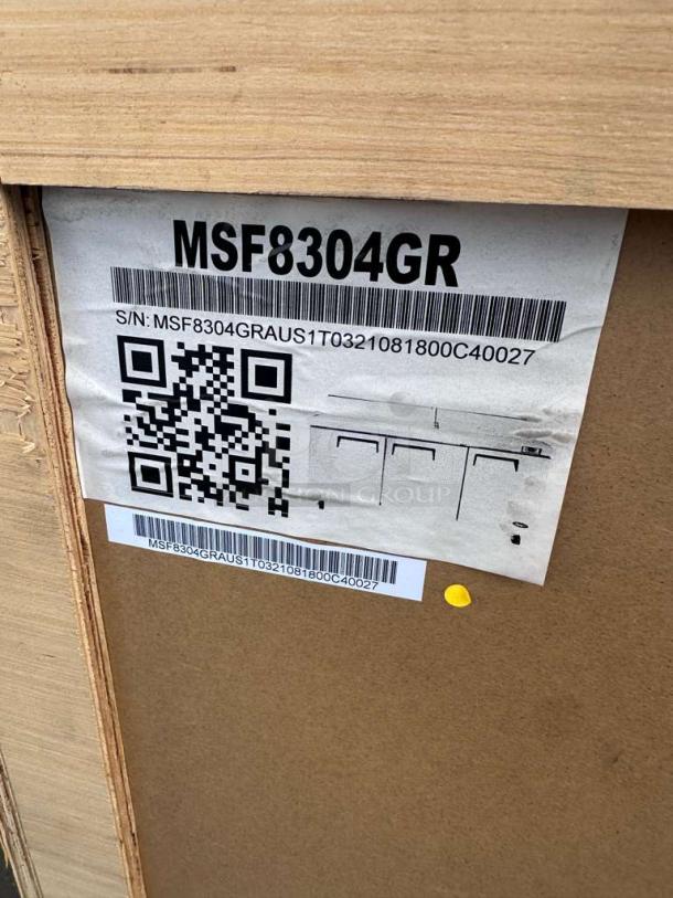 Barcoded label on packaging for Atosa MSF8304GR 3-Door Mega Top Sandwich Prep Table Refrigerator, model details visible.