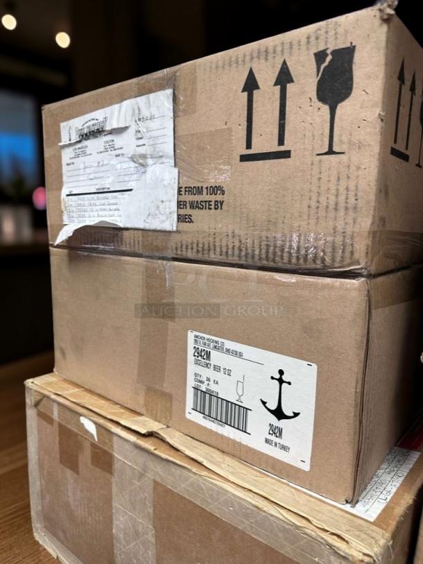 Boxes of Anchor Hocking Excellency 2942M beer glasses, 10 oz, 72 glasses total. Labels indicate model and origin.