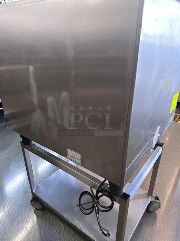 Elite Condition Rational SelfCookingCenter commercial combi oven, 6-pan capacity, digital controls, fully operational, back view showing stainless steel exterior and power cord on stand.