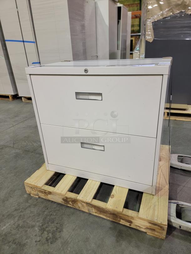 HON 30" lateral file cabinet with two drawers, central lock, and key. Durable powder-coated finish, steel construction.