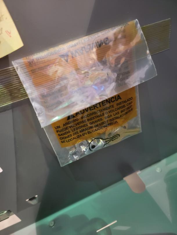 A close-up shows a bag attached to HON file cabinets containing keys and screws, with a safety warning label in multiple languages.