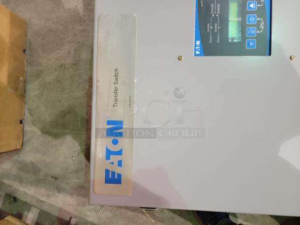 Eaton ATC-300 Transfer Switch, new condition, LCD display, LED indicators, manual controls, wall-mount design.