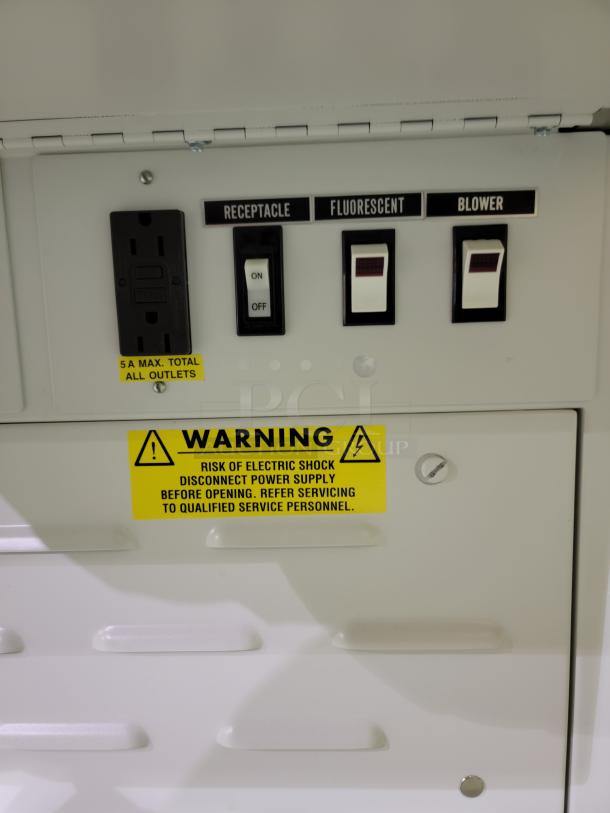 Control panel of Baker EdgeGard HF Clean Bench, Model SG6252, showing switches for receptacle, fluorescent lighting, and blower. Warning label advises on electrical safety.