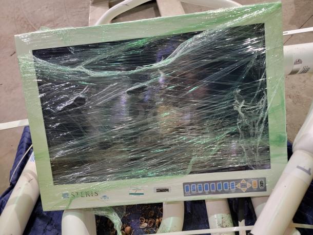 Steris Harmony LED surgical lighting system, wrapped and displayed with ceiling mount hardware, featuring LED heads for precise illumination.