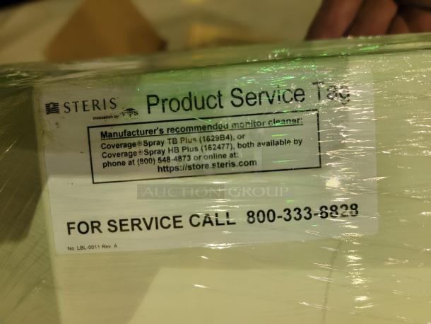 Steris Harmony LED surgical lighting system packaging with service tag, includes cleaning product recommendations and service number.
