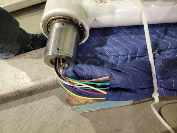 Steris Harmony LED surgical lighting system component with wiring, shown during setup on a padded surface.