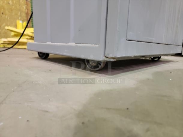 FOX Compactors 2430 industrial waste compactor with caster wheels for easy mobility. Heavy-duty steel frame shown.