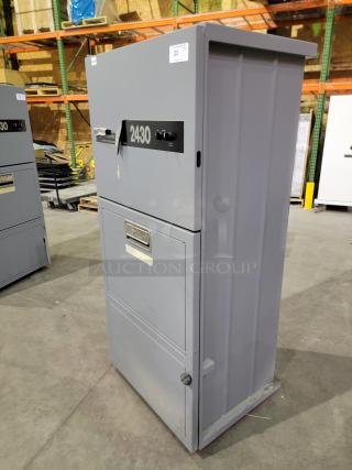 FOX COMPACTORS 2430 industrial waste compactor; sturdy gray steel frame, easy-to-remove bin on casters, two-dial controls, label with model number.
