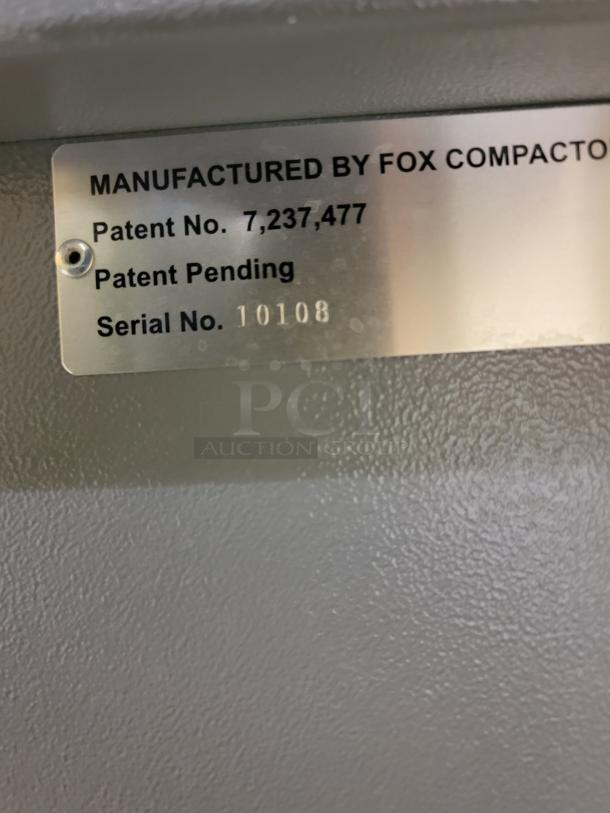 Metallic label on Fox Compactors 2430 unit displaying "Manufactured by Fox Compactors," patent number 7,237,477, and serial number 10108.