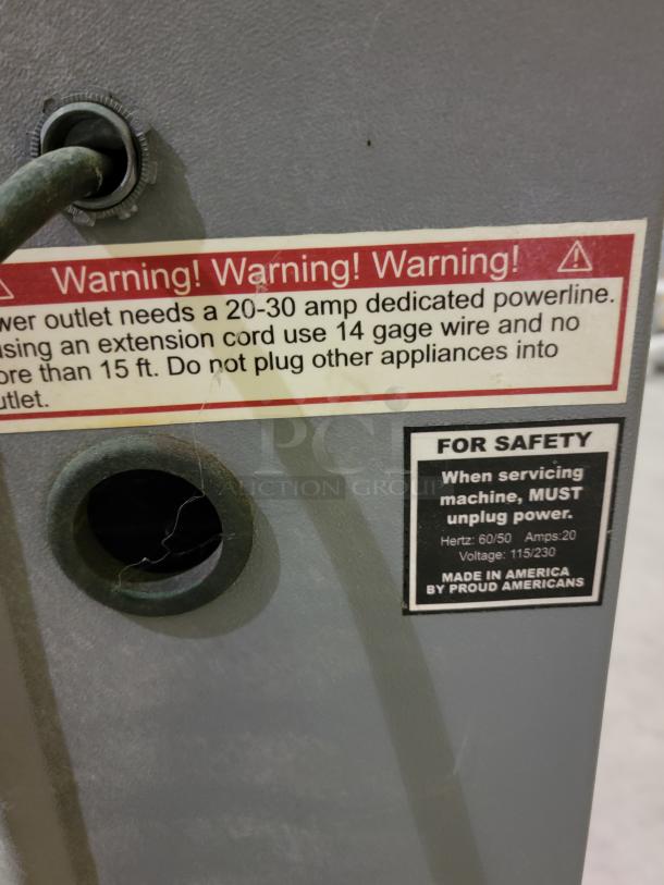 Alt text: Fox Compactors 2430 industrial waste compactor warning and safety labels. Requires 20-30 amp powerline. Made in America.