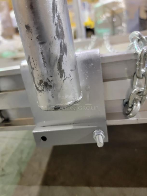 Close-up of Alco 14' aluminum walk ramp model AWR-28-14-H, showing robust construction and safety chain attachment.