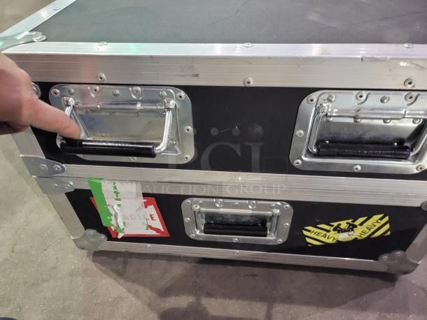 PENN-ELCOM 4' heavy-duty road case with black laminate, aluminum edges, foam interior, swivel casters, and secure latches.