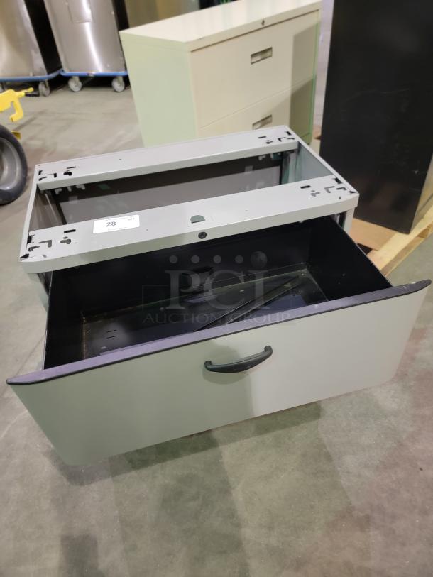 Mixed lot of 3 steel lateral file cabinets, featuring two black two-drawer and one white three-drawer units, in good condition.