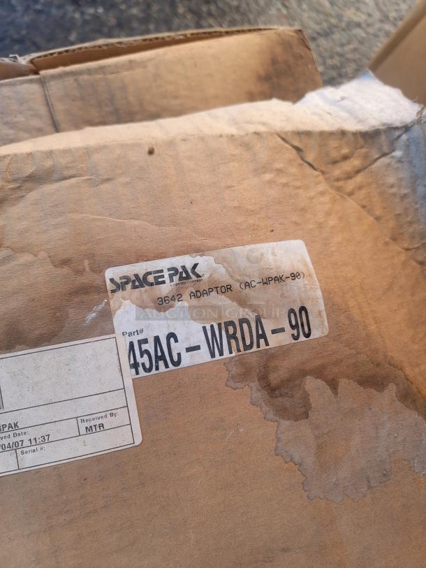 Cardboard box with SpacePak label for 3642 Adaptor AC-WPAK-90, part number 45AC-WRDA-90, shows new HVAC components.