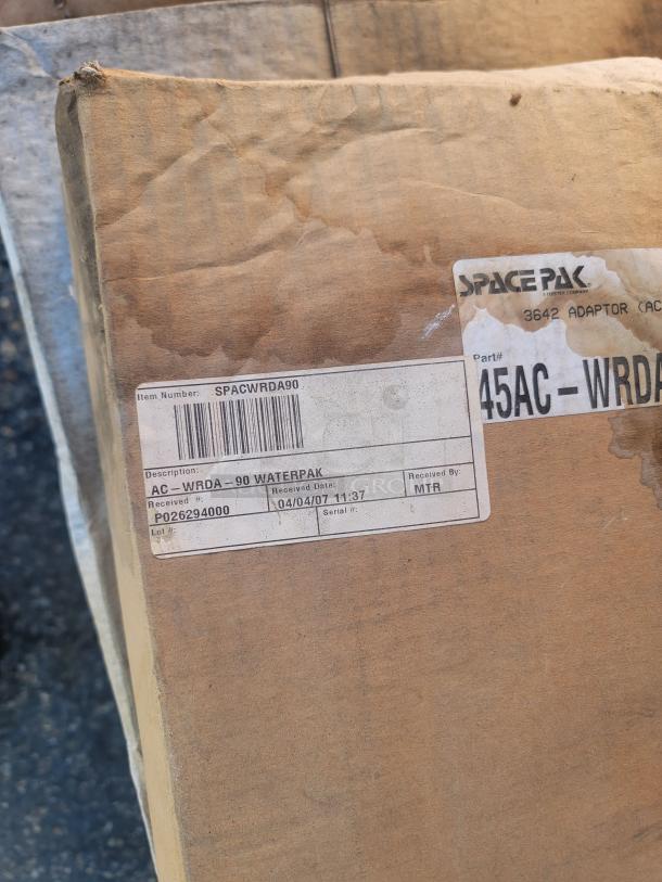 Box showing SpacePak AC-WRDA-90 WaterPak high-velocity HVAC system, label indicates inventory liquidation, received 04/04/07.