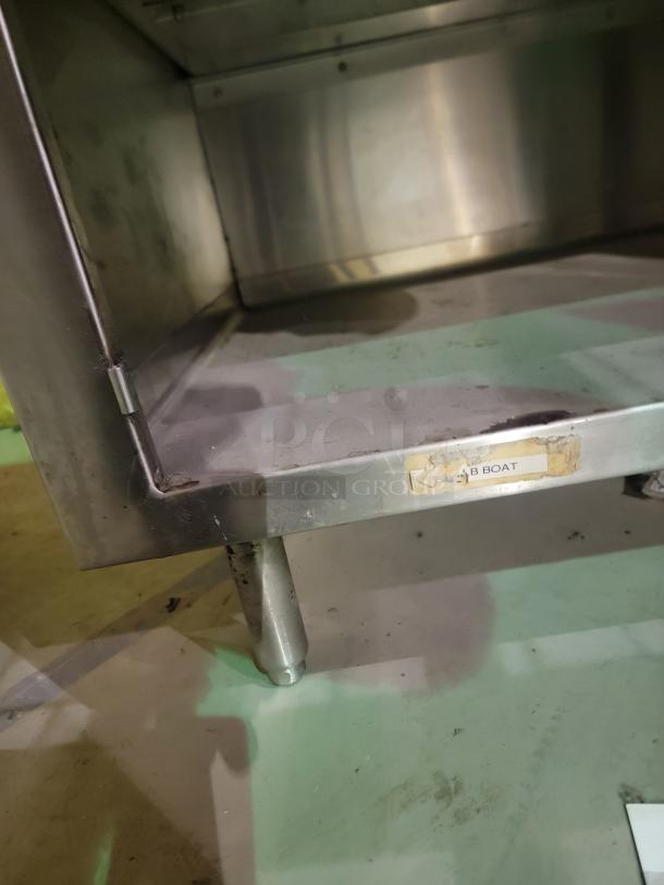 Regency stainless steel workstation with enclosed storage, 30" x 36", 4-inch backsplash, durable 14-gauge 304 steel.