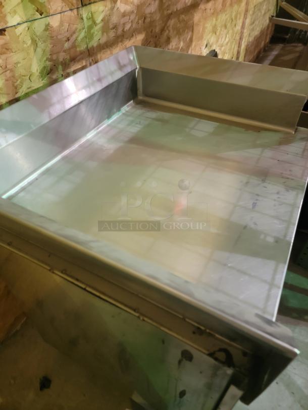 Regency stainless steel workstation, 30" x 36", with enclosed storage and 4" backsplash. Durable, non-porous surface.