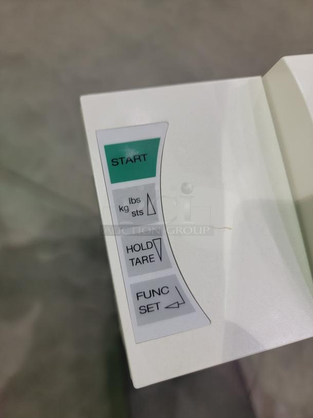 Seca 703 digital scale control panel with start, hold/tare, and function/set buttons visible.