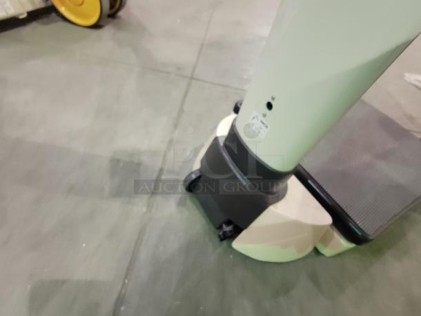 SECA 703 digital scale with cast-iron base, integrated wheels, and label visible. Features 550 lb capacity and BMI function.