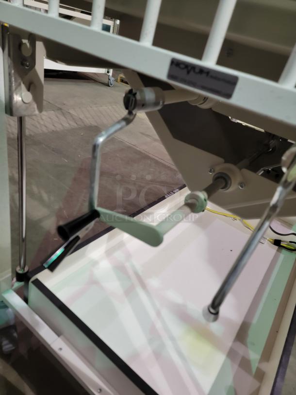 Novem E1982CGT pediatric crib with manual crank for height adjustment, safety side-gate, on swivel casters. Durable and mobile.