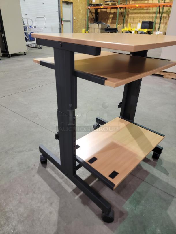 Mobile computer cart with three-tier design, black metal frame, wood surfaces, locking casters; ideal for workspace efficiency.