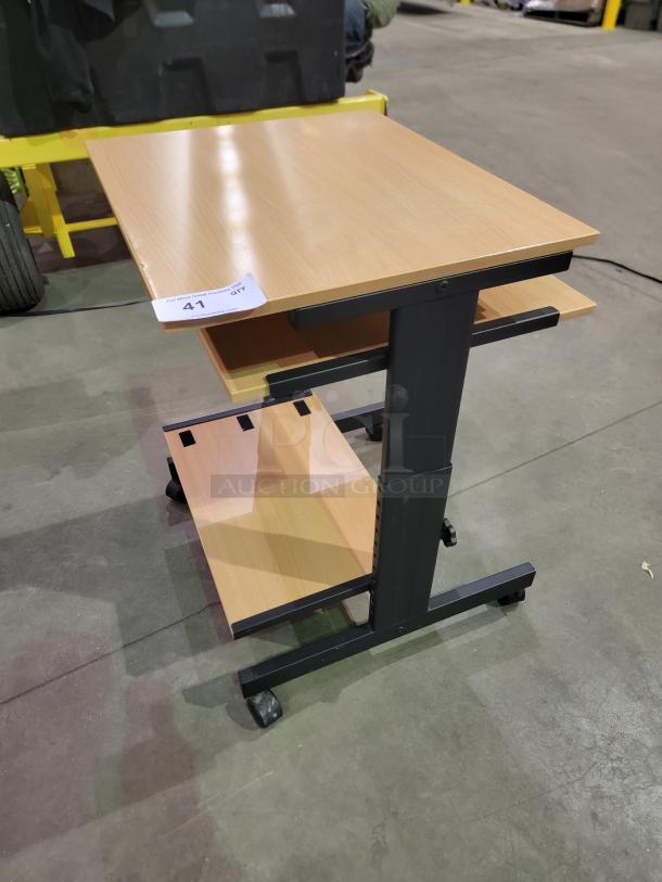 Three-tier mobile computer cart with slide-out keyboard tray, lower shelf, and black metal frame. Durable casters included.