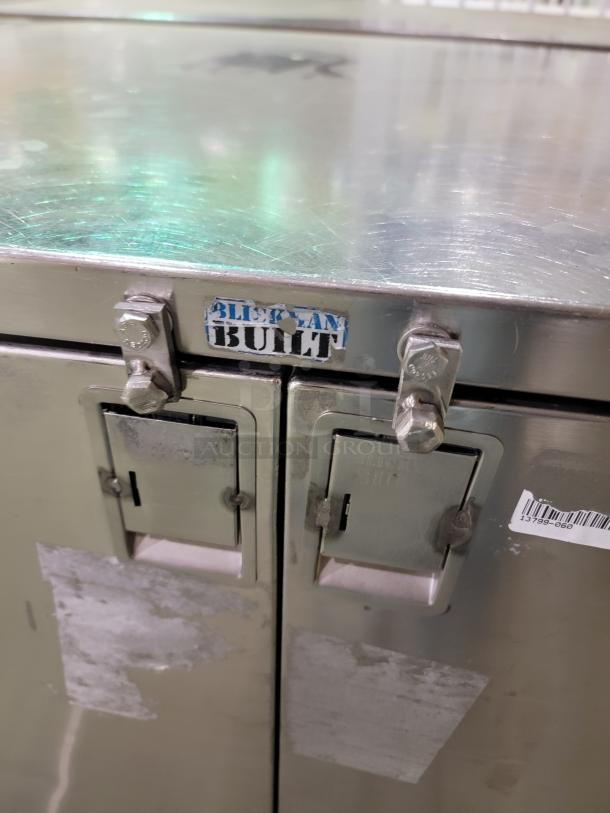 SUBURBAN SURGICAL CO. stainless steel case cart, double door, model Tote-AL Type C, with adjustable wire shelves and swivel casters.