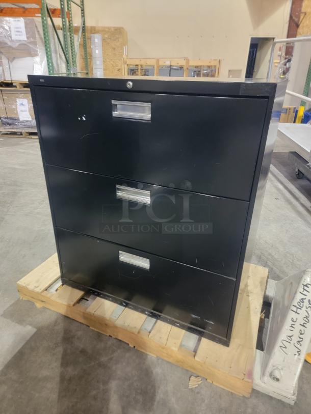 HON 683L black lateral filing cabinet with three drawers, reinforced steel frame, Accuride slides, no key, on pallet.