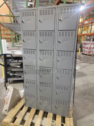 Lot of 3 Penco 6-tier box lockers on pallet. Gray steel with ventilation, recessed handles, and label holders. 54 compartments total.