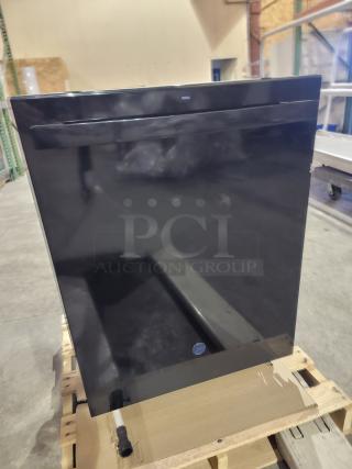 "New GE dishwasher with top-control design, black finish, and Dry Boost technology, on display in a warehouse setting."