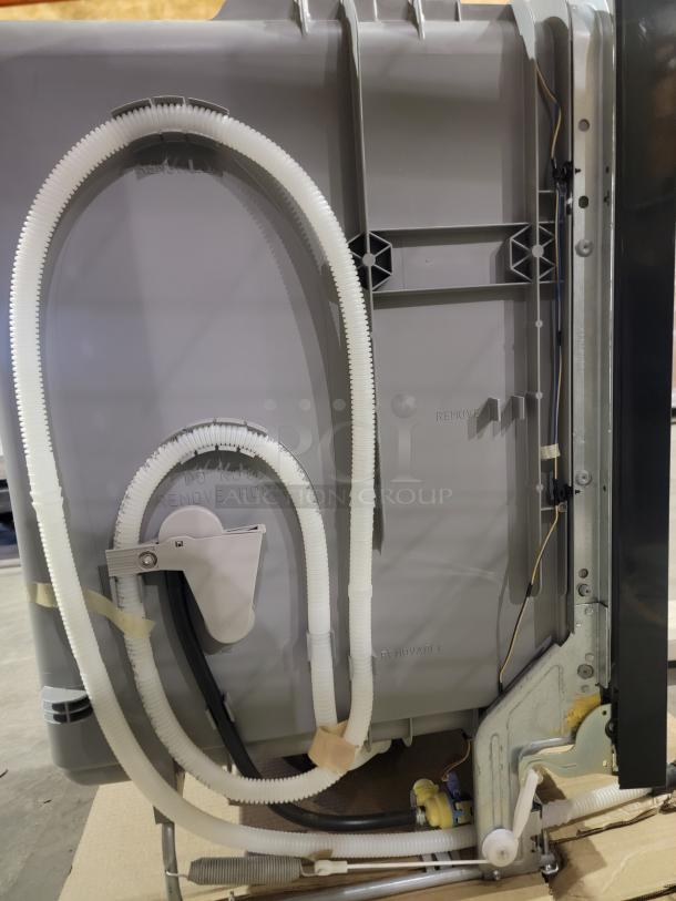 Brand new GE dishwasher, side view. Features hoses and paneling. Top-control model in sleek black. Includes Dry Boost and Steam Prewash.