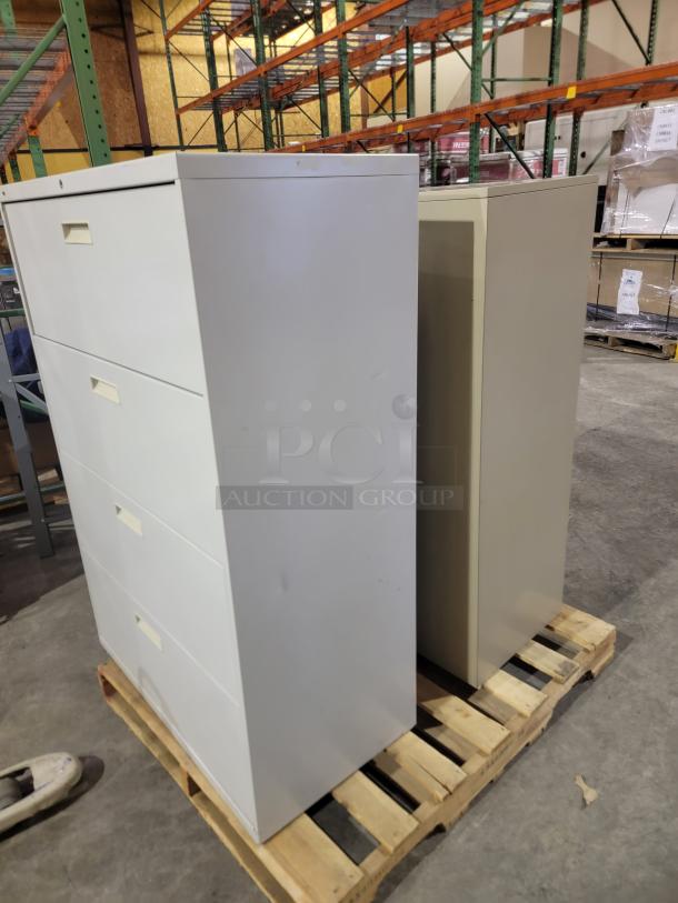 Pair of Hon 500 Series lateral filing cabinets, steel, wide drawers for letter/legal files, one with key, on a pallet.