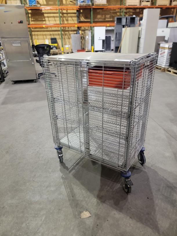 METRO QwikTrak mobile security cart, chrome wire, double-door lock, swivel casters, top work surface, organizing bin.