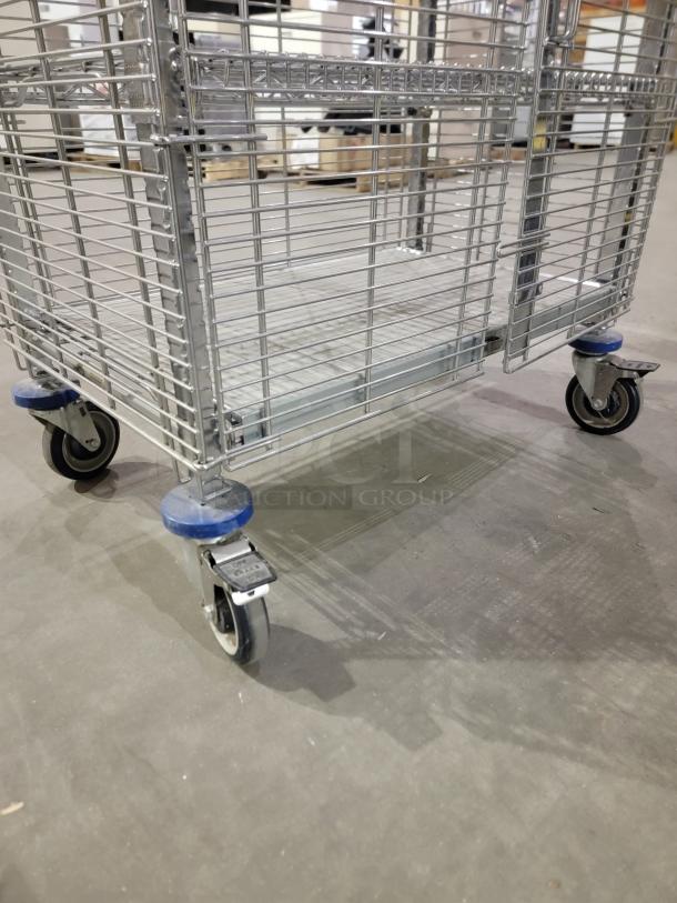 Metro QwikTrak mobile security cart with chrome wire construction, swivel casters, and double-door lock for secure storage.