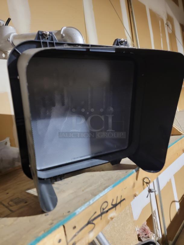 Campbell Company pedestrian crossing signal with deep sun visor, LED head, durable construction, resting on a wooden shelf.