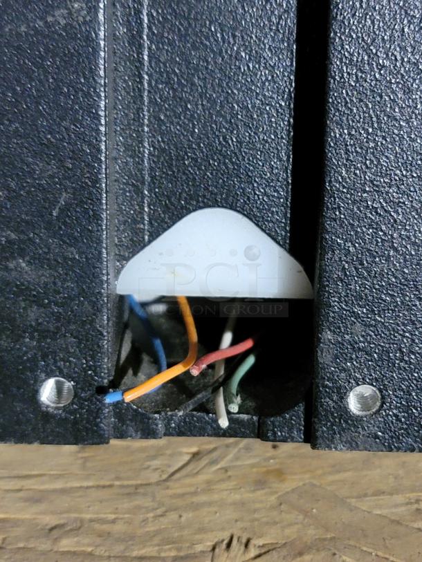 Close-up of Campbell pedestrian signal wiring with red, green, orange, and blue leads emerging from the base.