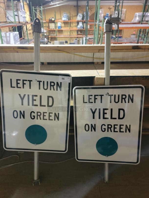 Lot of 2 Pelco PM-5089 adapters with 24x30 "Left Turn Yield on Green" signs, mounted on aluminum poles.