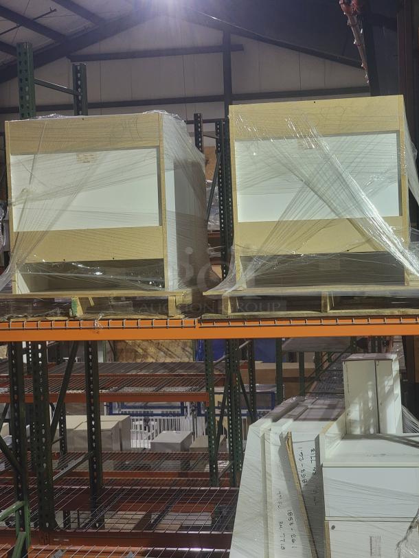 Bulk lot of Metro Lionville Series cabinets and Corian Glacier White sinks, new and wrapped, on warehouse shelves.