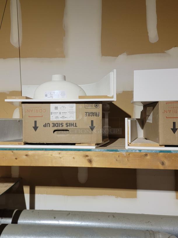 Boxes of Metro Lionville Series cabinets and Corian Glacier White sinks in storage, showcasing new inventory condition.