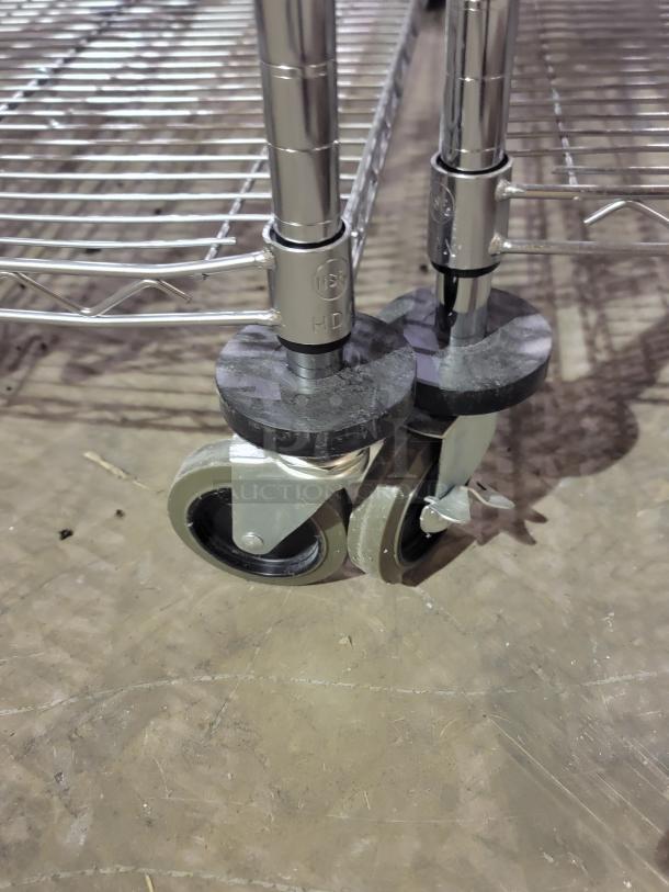 Chrome-plated Metro Super Erecta shelving with smooth-rolling stem casters and protective bumpers, shown on a warehouse floor.