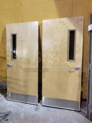 Lot of 2 Lambton 20-minute fire-rated wood doors with frames, solid wood core, vision lites, stainless steel kick plates, weather-strip sweeps.