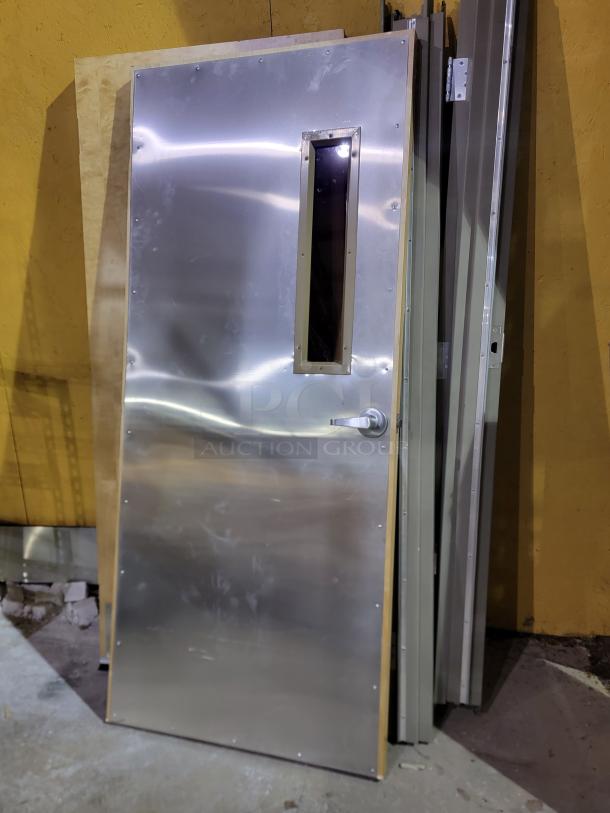 Lot of 2 Lambton 20-minute fire-rated wood doors with frames. Includes stainless steel kick plates, vision lite, and protective sheet.