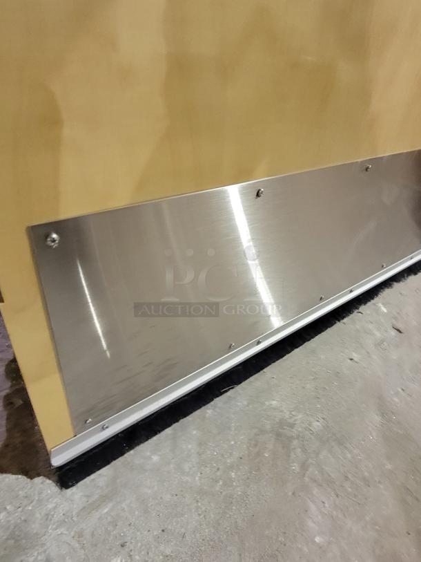 Lambton fire-rated wood door with stainless steel kick plate and weather-strip, showcasing durable construction and protective features.